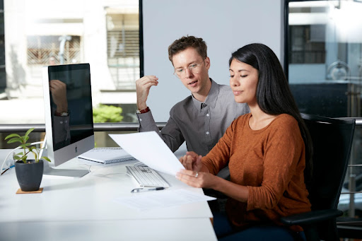 Two professional linguists with experience in finance discussing a document.