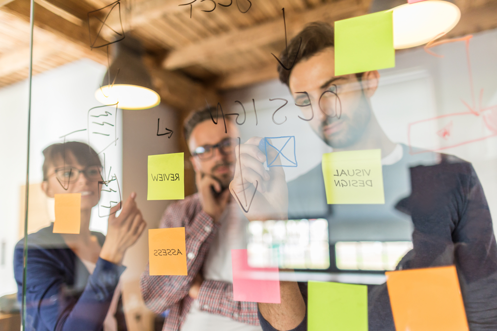 a group of transcreators brainstorming in their office