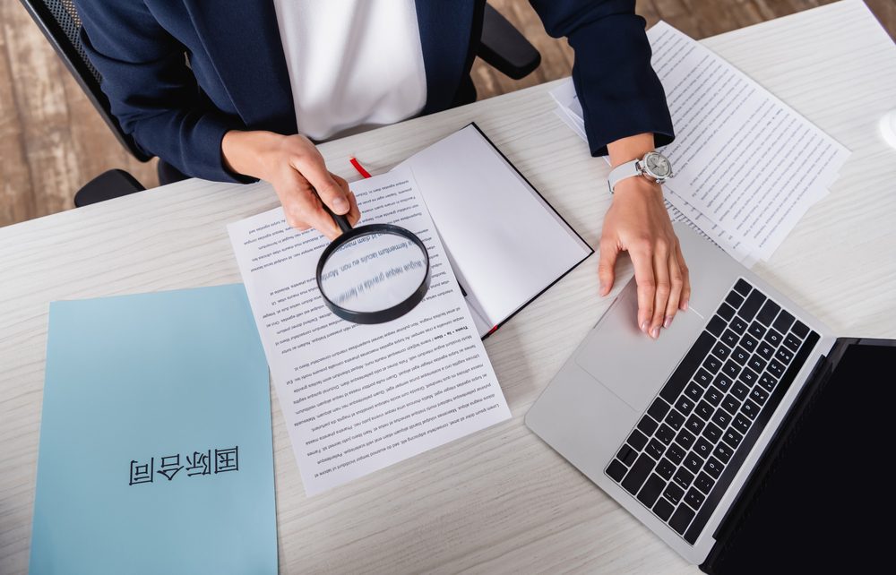 a woman conducting human translaiton for a legal document